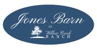 Jones Barn at Willow Creek Ranch logo displayed inside a blue oval with white script lettering and a small tree illustration.