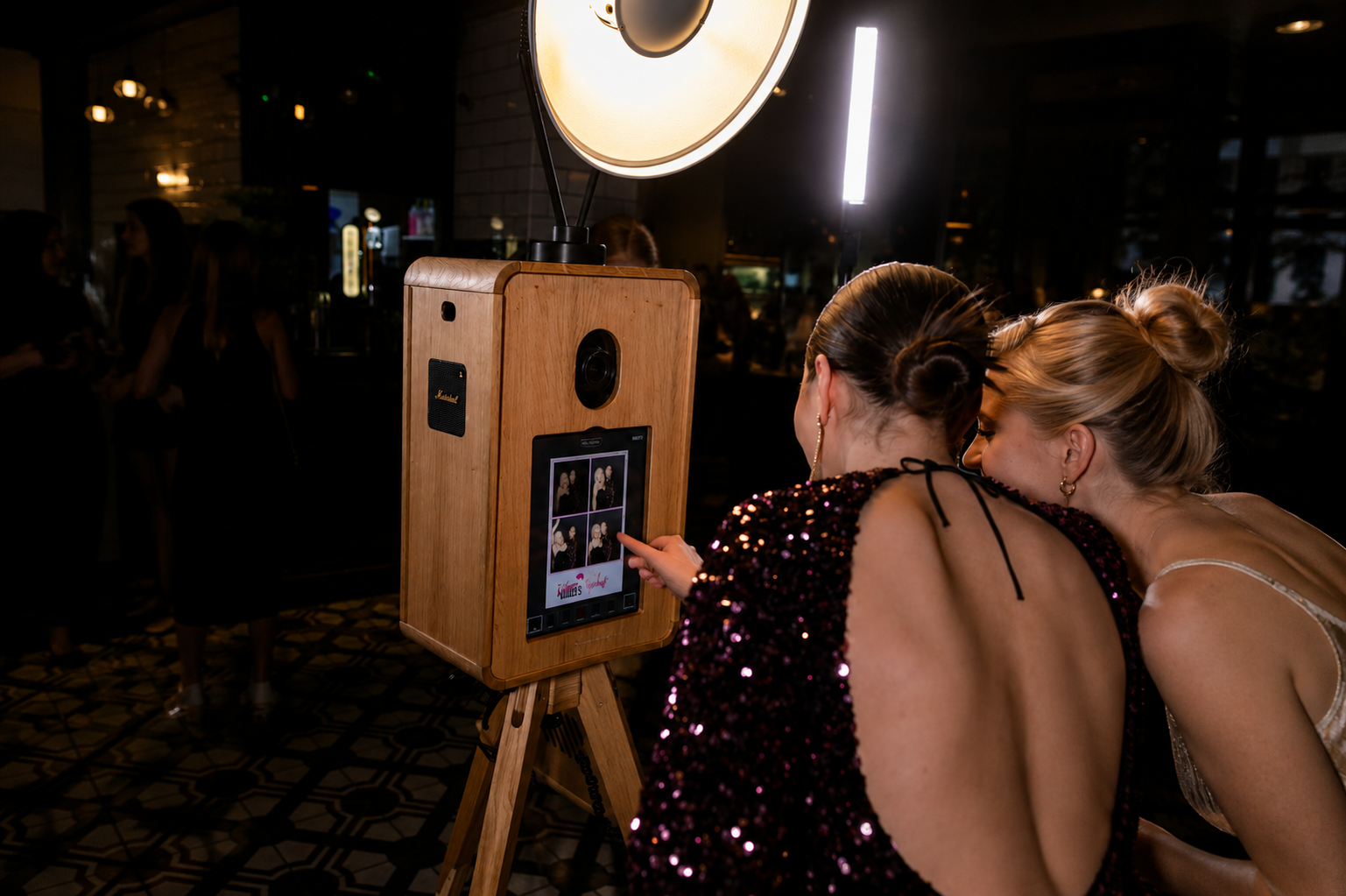 Ladies night photo booth fun Event guests using a luxury photo booth in DFW